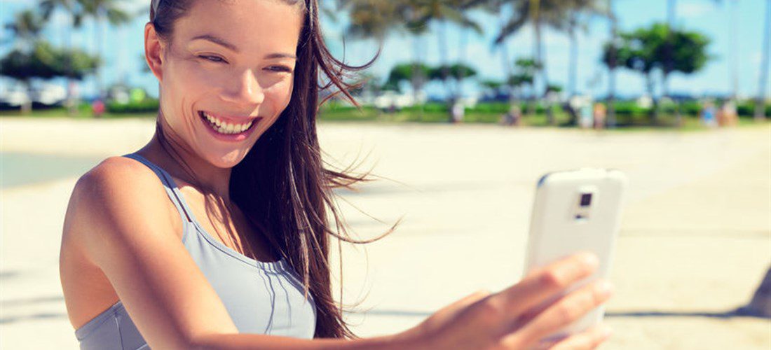 woman taking a confident selfie after cosmetic procedure